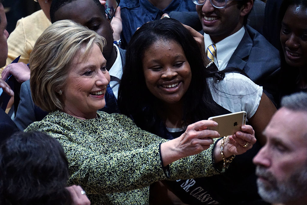 Hillary Clinton takes a selfie during a campaign rally in Durham, North Carolina at Hillside High School.